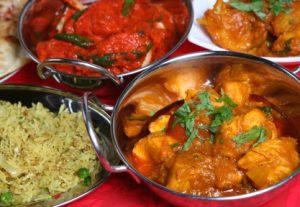 Indian curry meal with rice, nan and begetables